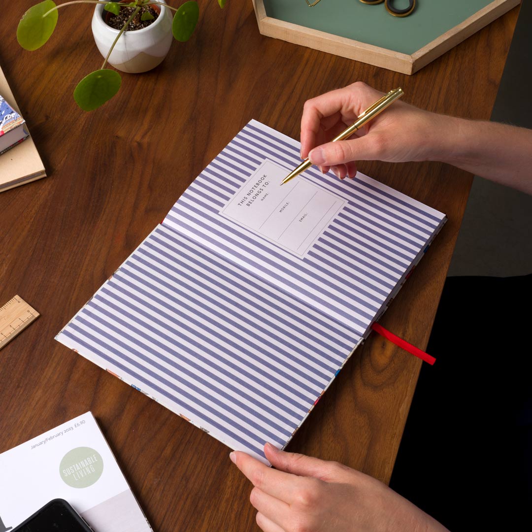 Person writing in an open notebook