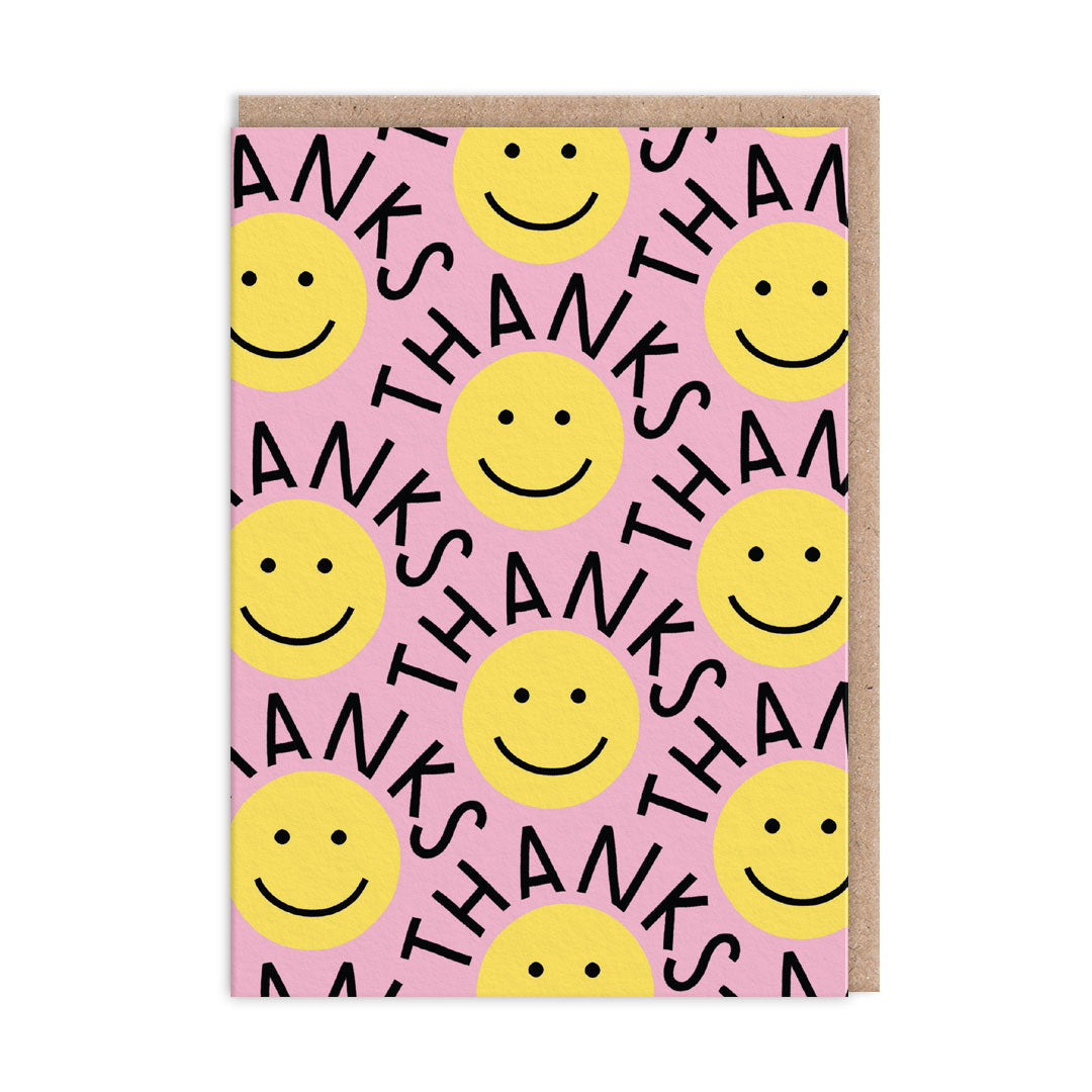 Pink thank you card with repeat illustrations of Yellow Smiley Faces and black text that reads"Thanks" wrapping around each face