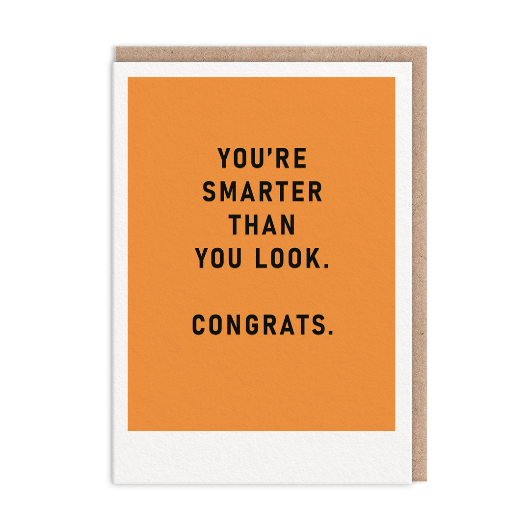 Congratulations card with an orange background and black text that reads "You're Smarter Than You Look. Congrats"