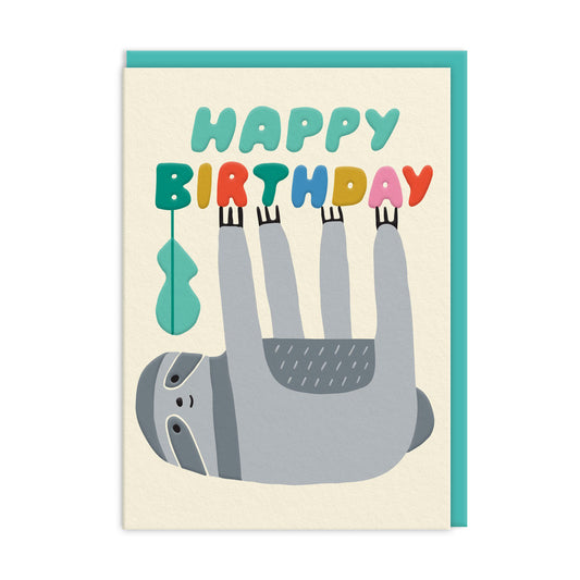 Neutral background with an illustration of a grey sloth hanging upside from the text, which reads "happy birthday"